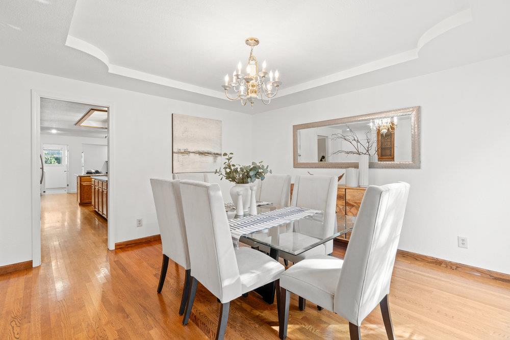 10930 Miramonte Road Cupertino, CA 95014 - Photo 12 of 50 a dining room with furniture a chandelier and wooden floor