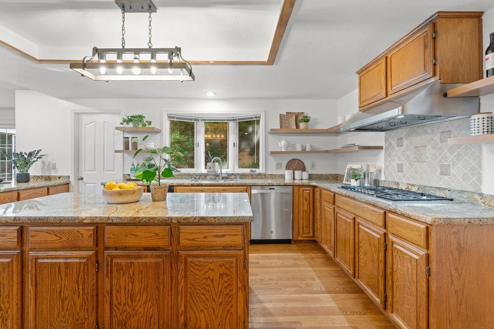 10930 Miramonte Road Cupertino, CA 95014 - Photo 15 of 50 a kitchen with stainless steel appliances granite countertop a sink and stove top oven