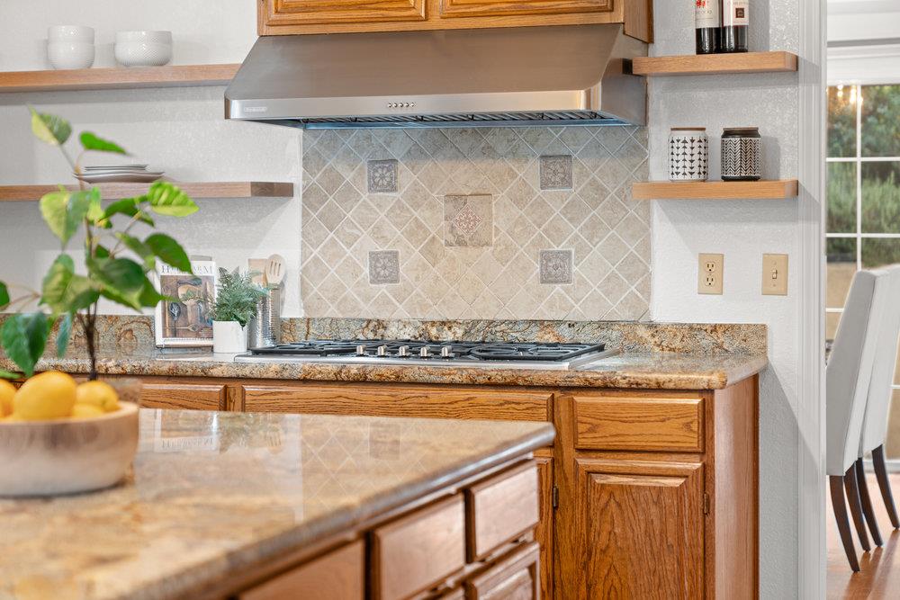 10930 Miramonte Road Cupertino, CA 95014 - Photo 16 of 50 a kitchen with a stove a mirror and a sink