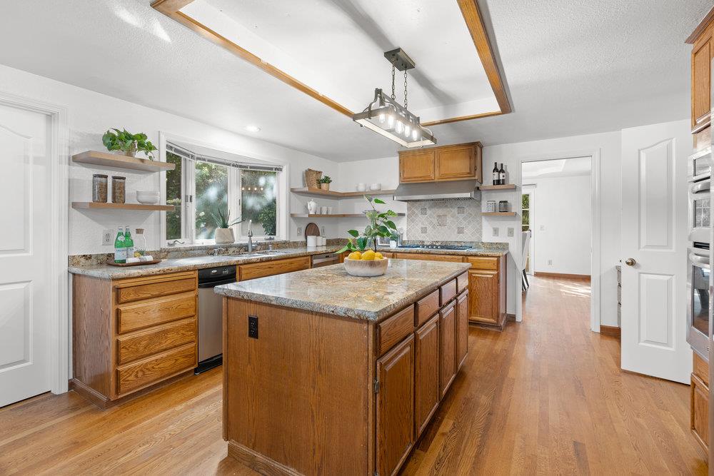 10930 Miramonte Road Cupertino, CA 95014 - Photo 17 of 50 a kitchen with granite countertop a sink a counter top space and stainless steel appliances