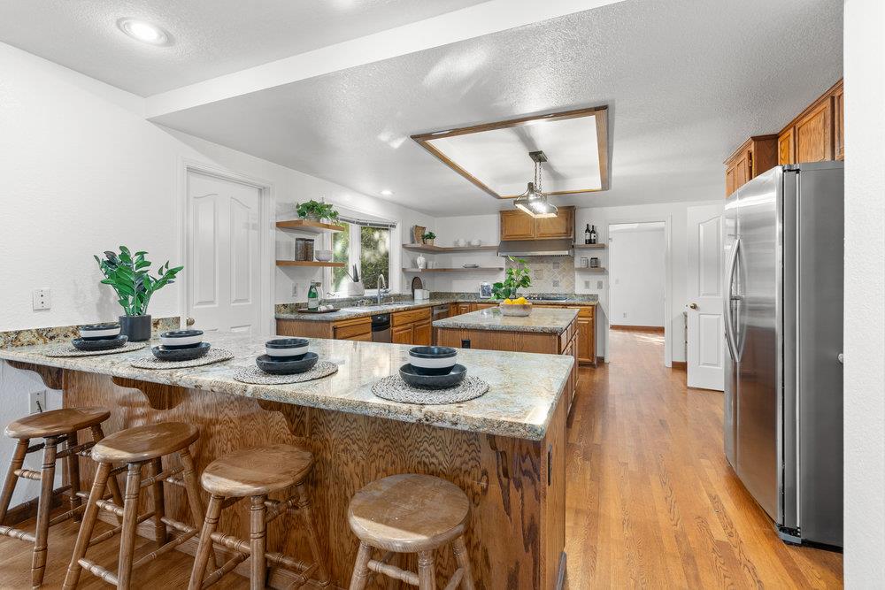 10930 Miramonte Road Cupertino, CA 95014 - Photo 18 of 50 a kitchen with sink refrigerator and cabinets