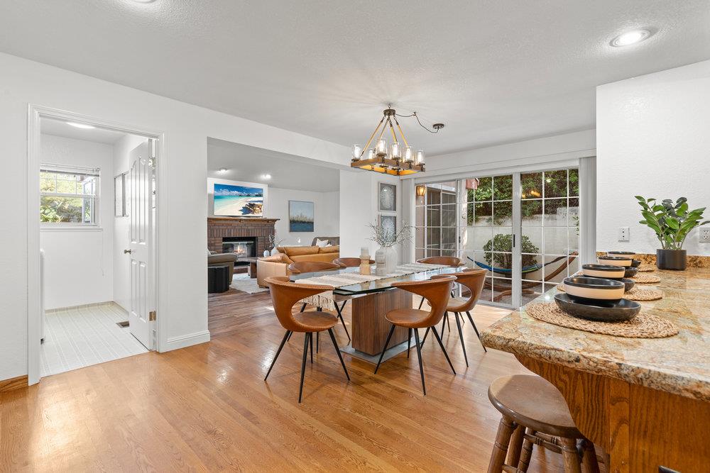 10930 Miramonte Road Cupertino, CA 95014 - Photo 20 of 50 a dining room with furniture a chandelier and wooden floor