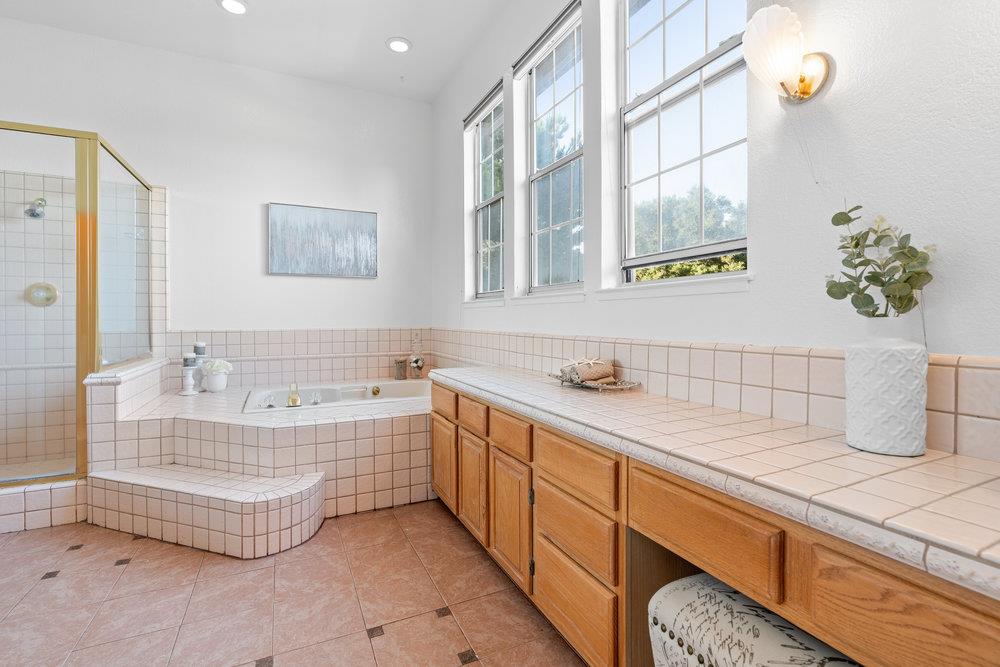 10930 Miramonte Road Cupertino, CA 95014 - Photo 31 of 50 a bathroom with a tub sink and mirror