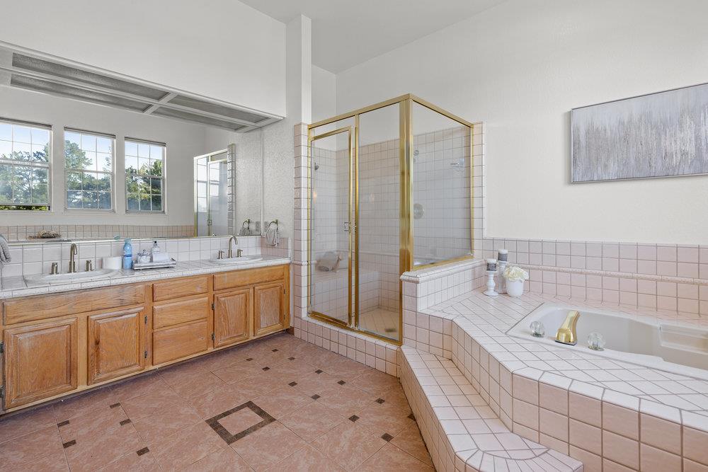 10930 Miramonte Road Cupertino, CA 95014 - Photo 32 of 50 a large bathroom with a tub sink shower and mirror