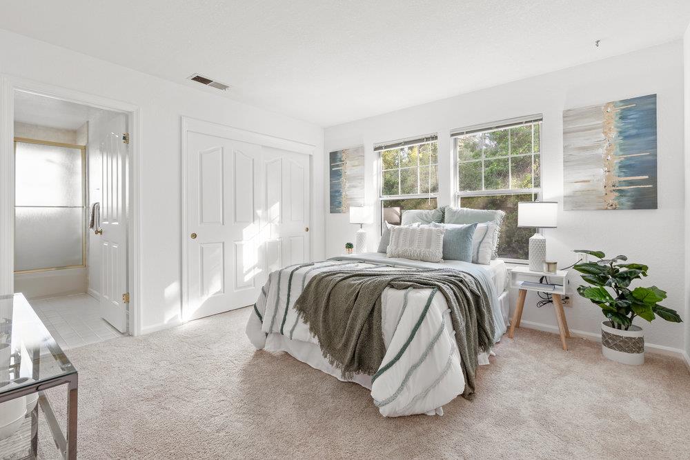 10930 Miramonte Road Cupertino, CA 95014 - Photo 34 of 50 a spacious bedroom with a bed and a couch