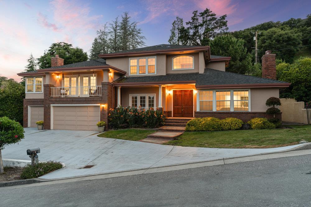 10930 Miramonte Road Cupertino, CA 95014 - Photo 48 of 50 a front view of a house with a yard and potted plants