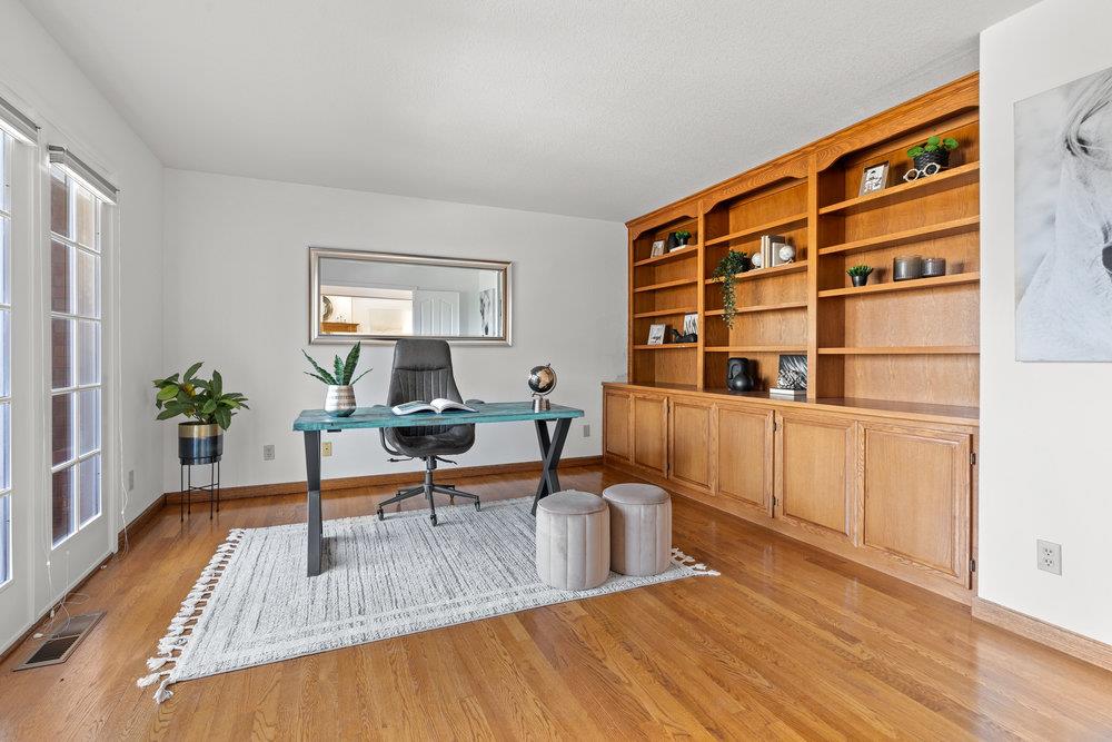 10930 Miramonte Road Cupertino, CA 95014 - Photo 8 of 50 a living room with furniture and a book shelf
