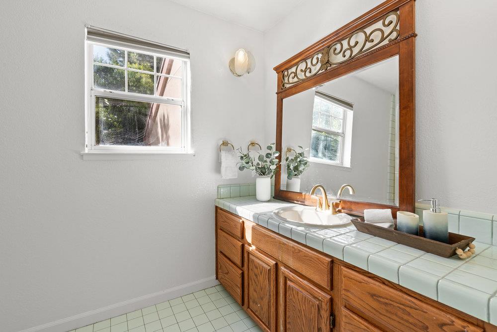 10930 Miramonte Road Cupertino, CA 95014 - Photo 10 of 50 a bathroom with a sink and a mirror