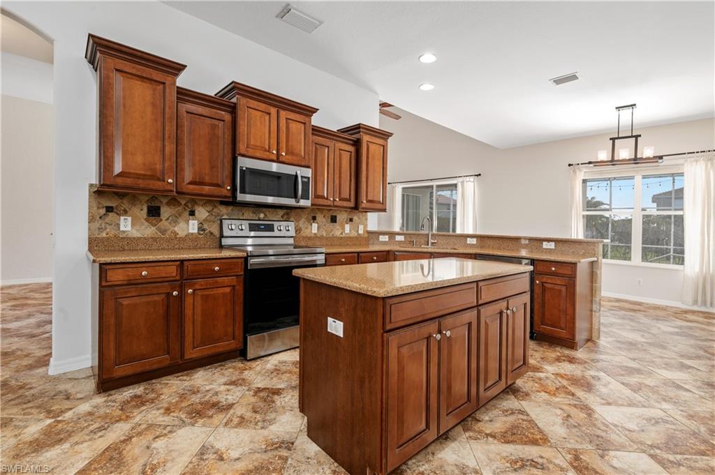 12446 Rock Ridge Lane Fort Myers, FL 33913 - Photo 3 of 38 a kitchen with a sink stove top oven and granite counter top