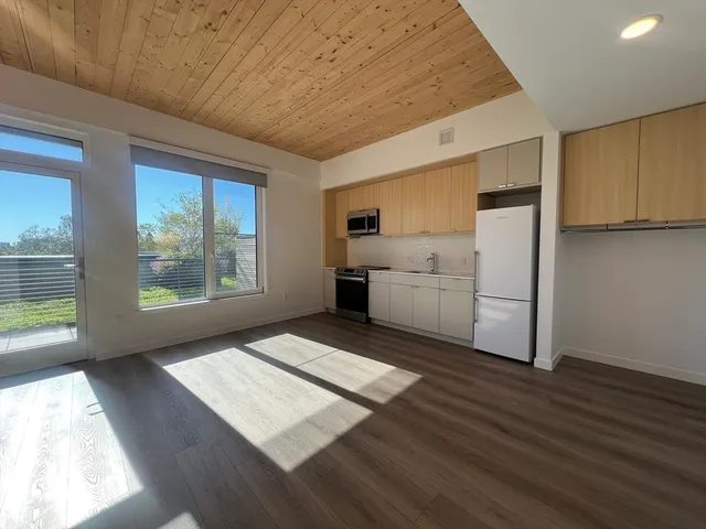 a living room with hard wood floors and furniture