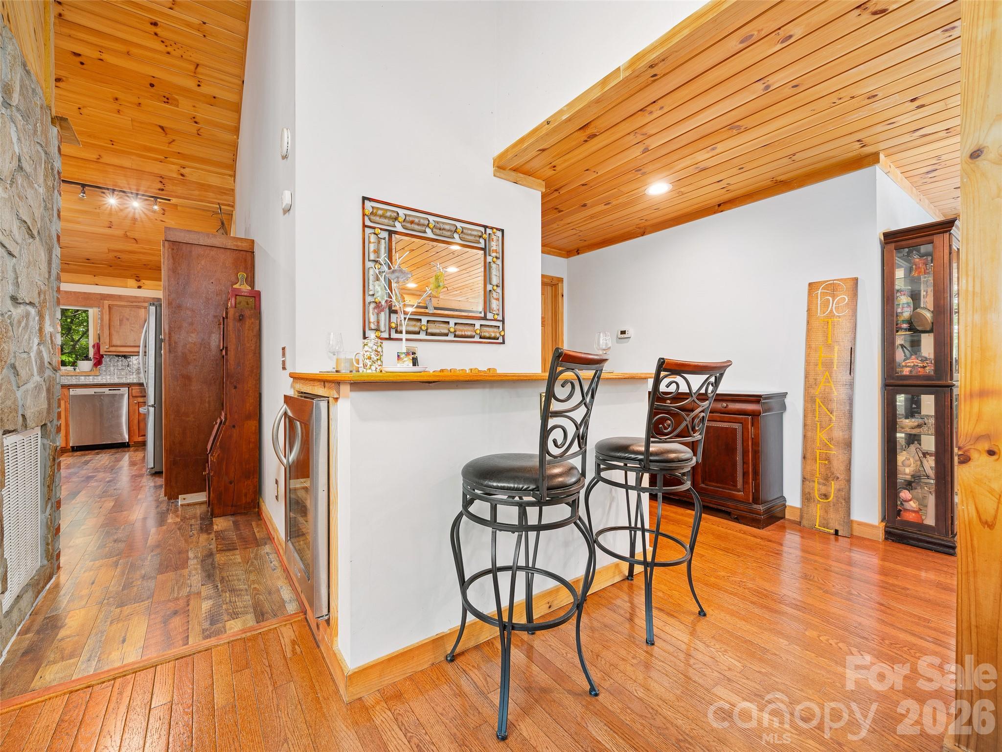 228 Continental Divide Road Spruce Pine, NC 28777 - Photo 5 of 48 a view of a dining room with furniture and wooden floor