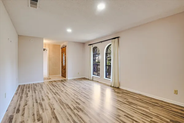 a view of an empty room and fire place