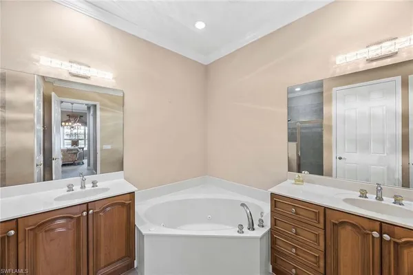 a bathroom with a tub sink and mirror