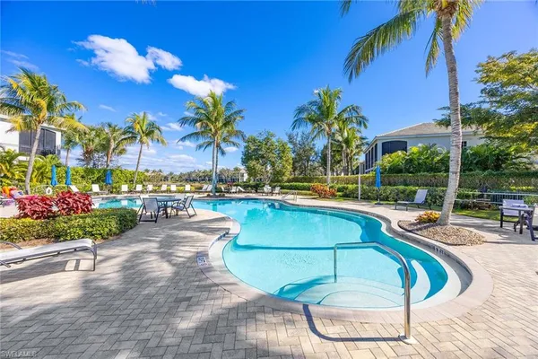 a view of a swimming pool and lounge chair