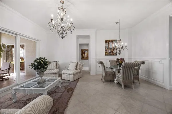 a living room with furniture chandelier and a chandelier