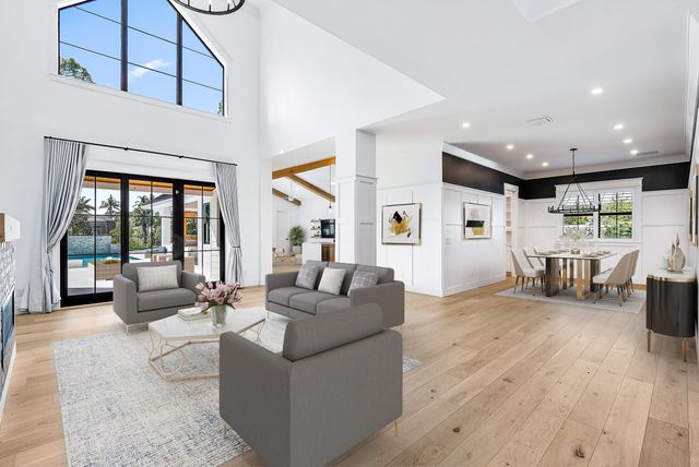 a living room with furniture a dining table and a potted plant