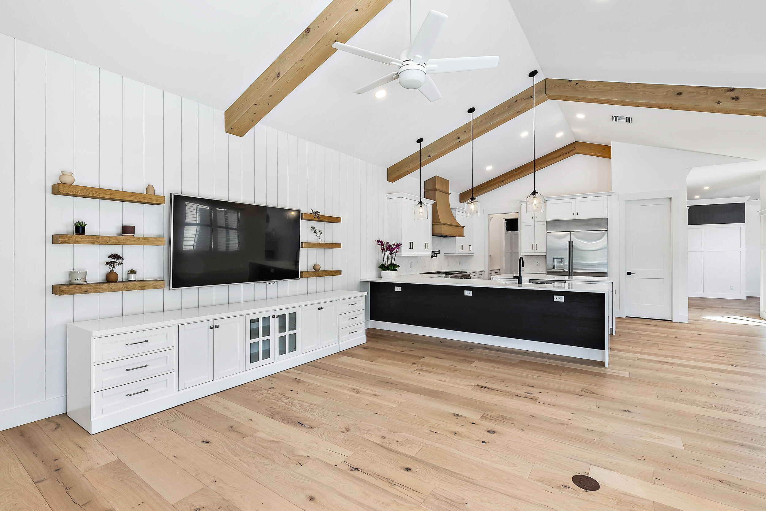 18764 Southeast Jupiter River Drive Jupiter, FL 33458 - Photo 34 of 67 a large white kitchen with kitchen island a sink stainless steel appliances and cabinets