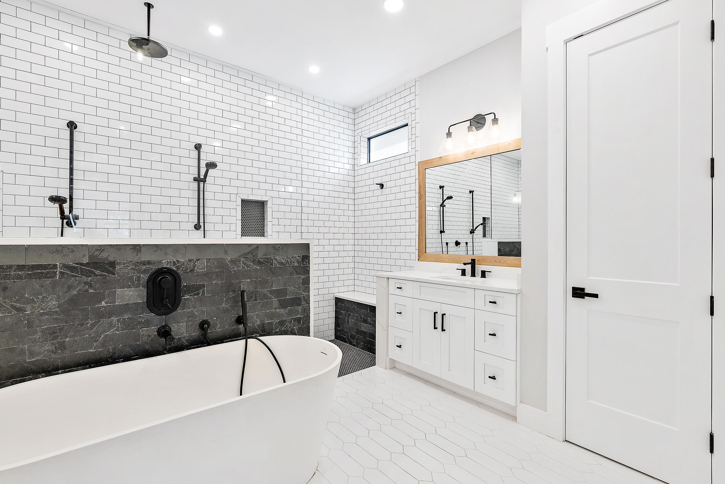 18764 Southeast Jupiter River Drive Jupiter, FL 33458 - Photo 42 of 67 a bathroom with a bathtub a double vanity sink a toilet a mirror and