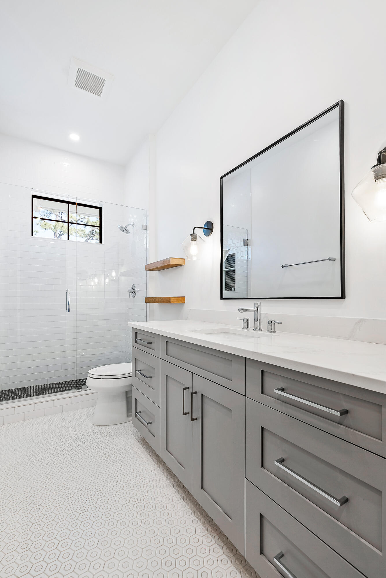 18764 Southeast Jupiter River Drive Jupiter, FL 33458 - Photo 50 of 67 a bathroom with a toilet sink and mirror