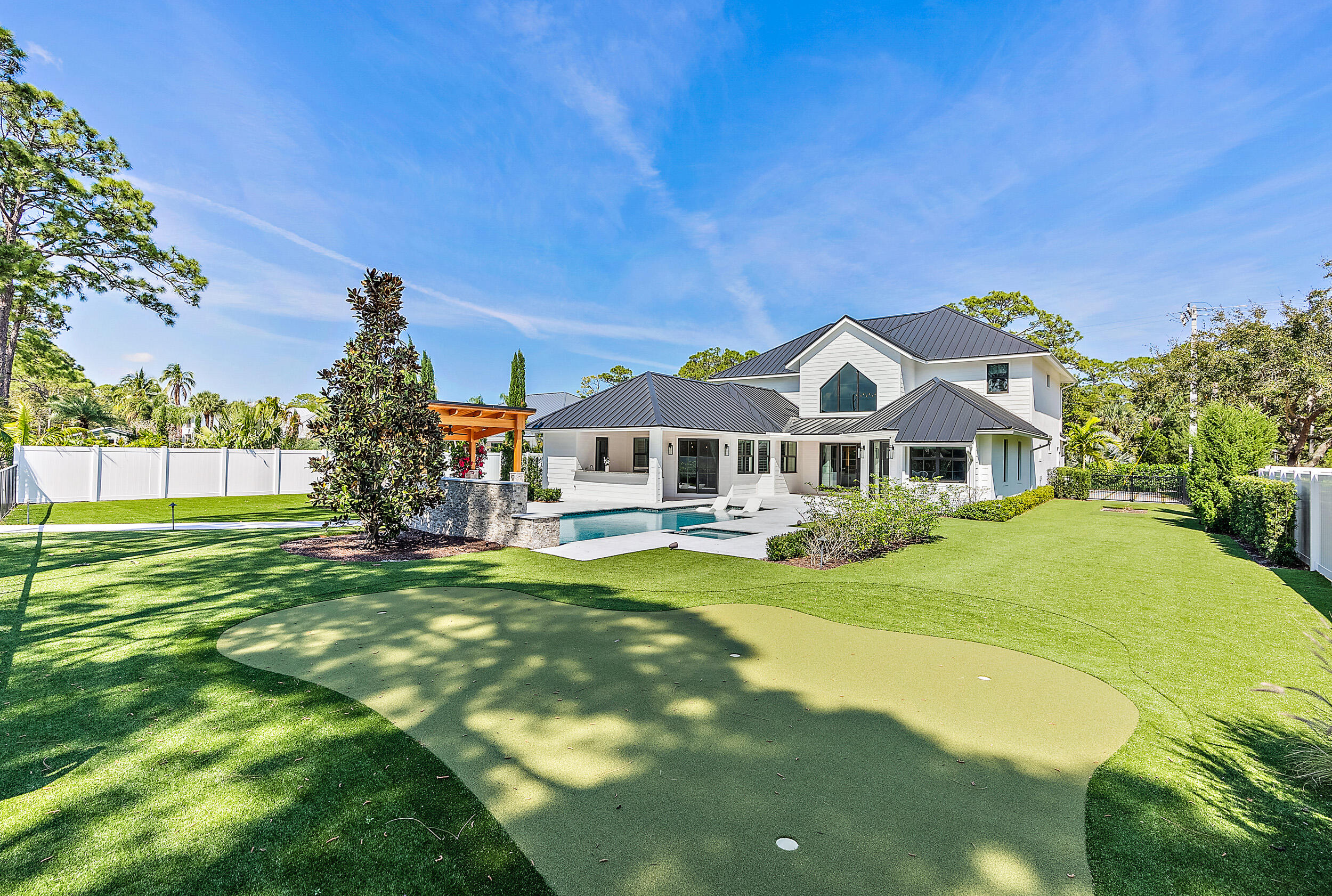18764 Southeast Jupiter River Drive Jupiter, FL 33458 - Photo 62 of 67 a front view of a house with a garden