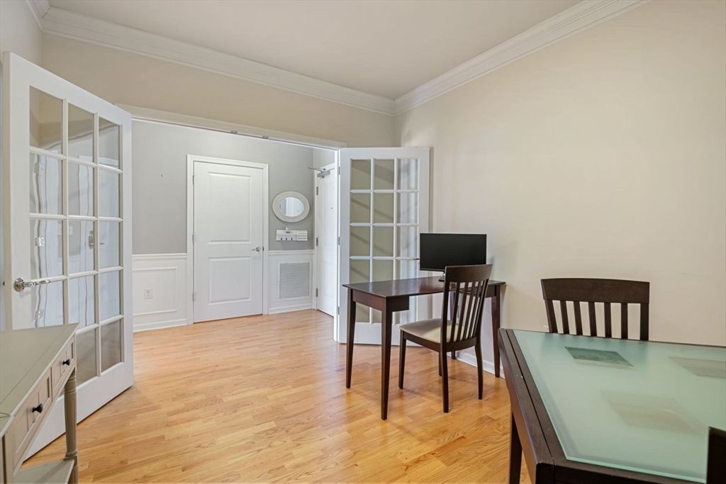 204 Clocktower Drive, Unit 202 Waltham, MA 02452 - Photo 12 of 25 a view of a dining room with furniture and wooden floor