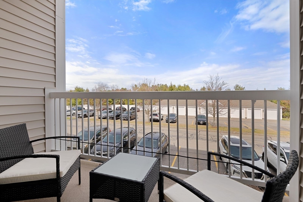 204 Clocktower Drive, Unit 202 Waltham, MA 02452 - Photo 21 of 25 a view of a balcony with chairs