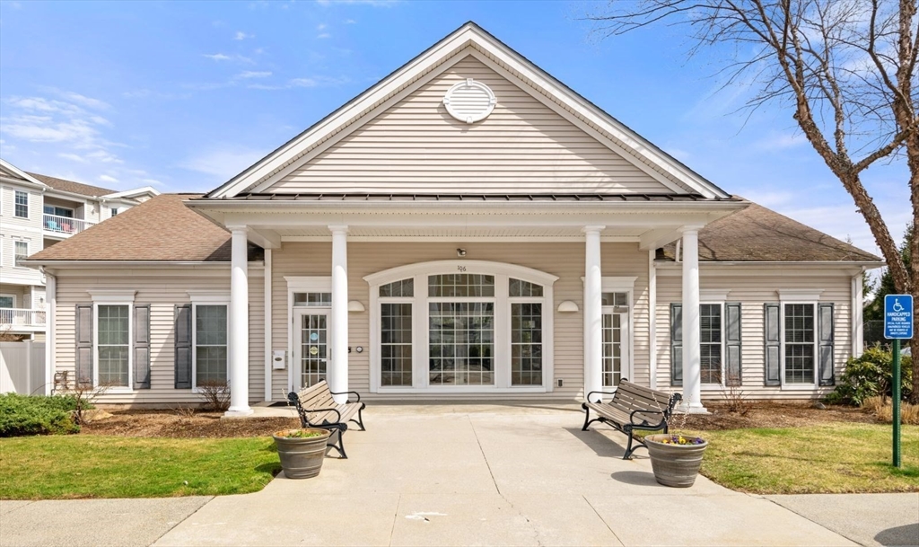 204 Clocktower Drive, Unit 202 Waltham, MA 02452 - Photo 23 of 25 a front view of a house with a yard and outdoor seating