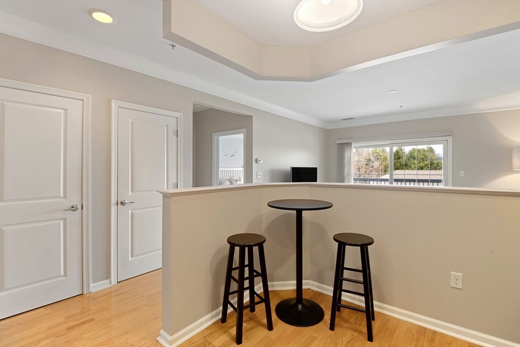 204 Clocktower Drive, Unit 202 Waltham, MA 02452 - Photo 7 of 25 a view of a room with furniture and a window