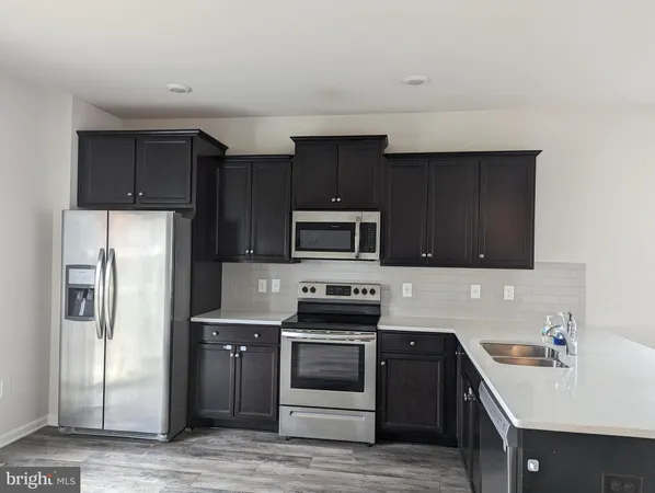 a kitchen with a refrigerator stove and sink