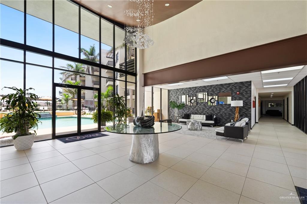 813 Travis Street, Unit 203 Mission, TX 78572 - Photo 2 of 30 a lobby with furniture and potted plants