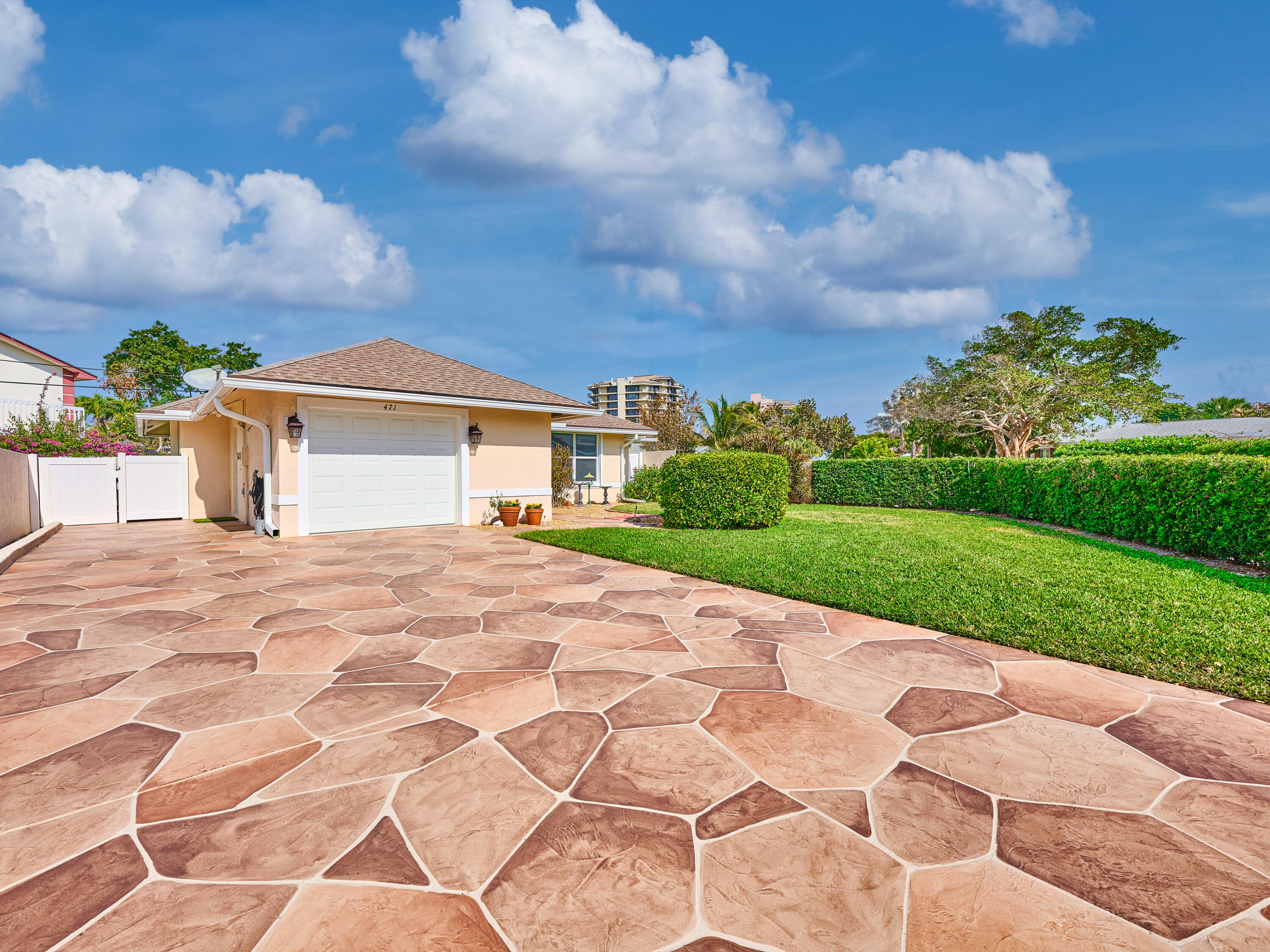 471 Neptune Road Juno Beach, FL 33408 - Photo 2 of 13 a front view of a house with a yard