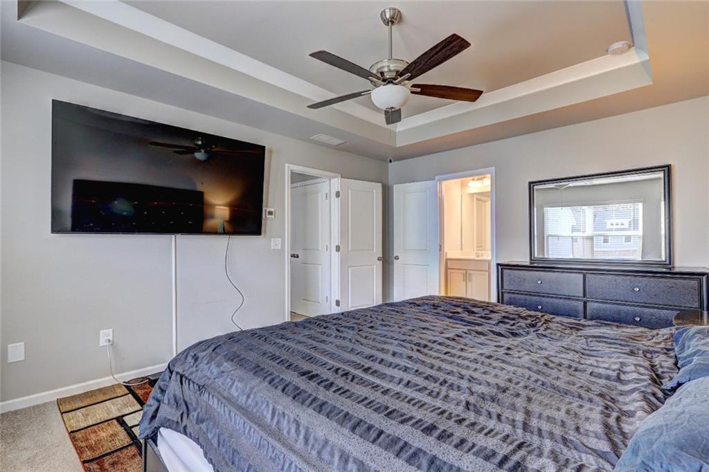 1123 Elyse Lane Mableton, GA 30126 - Photo 11 of 29 a bedroom with a bed and a flat screen tv