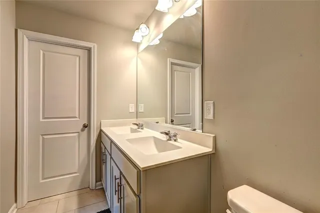 a bathroom with a sink a toilet and a mirror