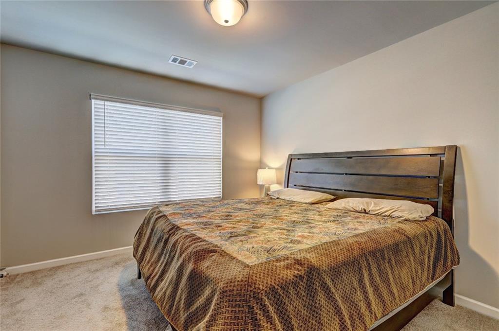 1123 Elyse Lane Mableton, GA 30126 - Photo 15 of 29 a bed sitting in a bedroom next to a window