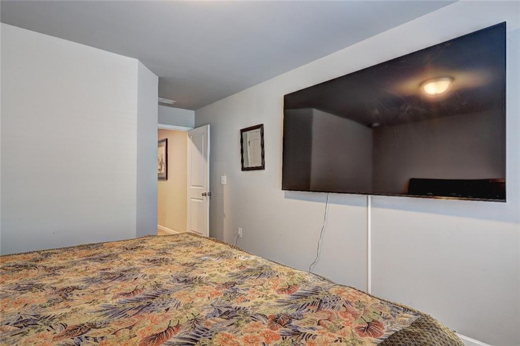 1123 Elyse Lane Mableton, GA 30126 - Photo 18 of 29 a bedroom with a bed and a flat screen tv