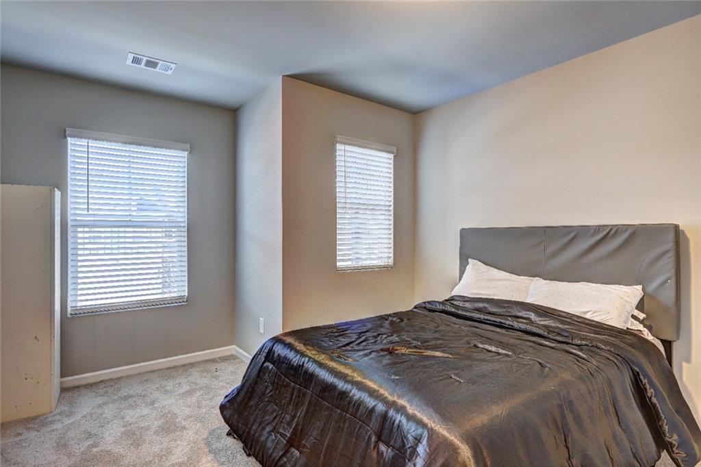 1123 Elyse Lane Mableton, GA 30126 - Photo 19 of 29 a bedroom with a bed and window