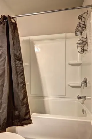 a bathroom with a shower and a sink