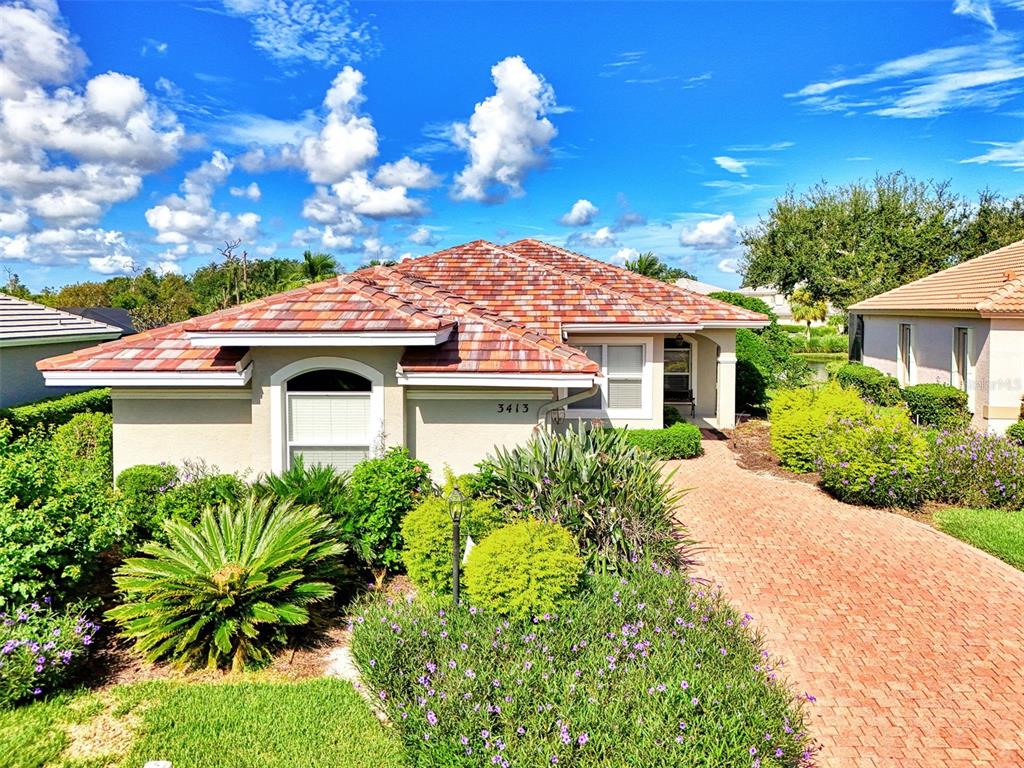 a front view of a house with a garden
