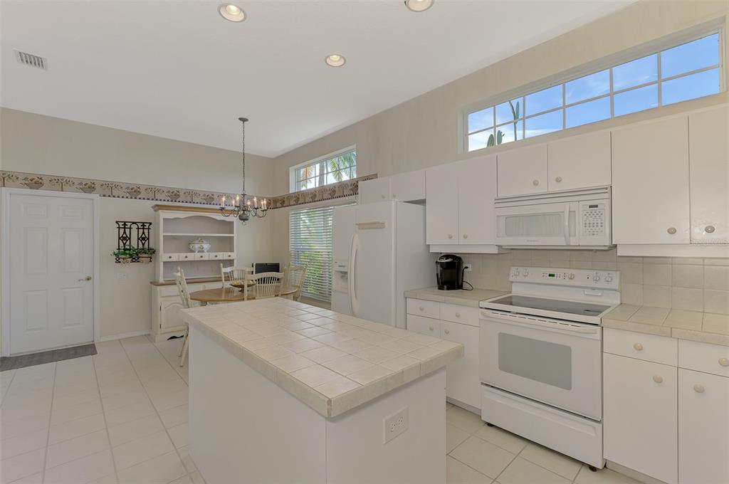 3413 Pennyroyal Road Port Charlotte, FL 33953 - Photo 18 of 88 a kitchen with a stove a sink and a refrigerator