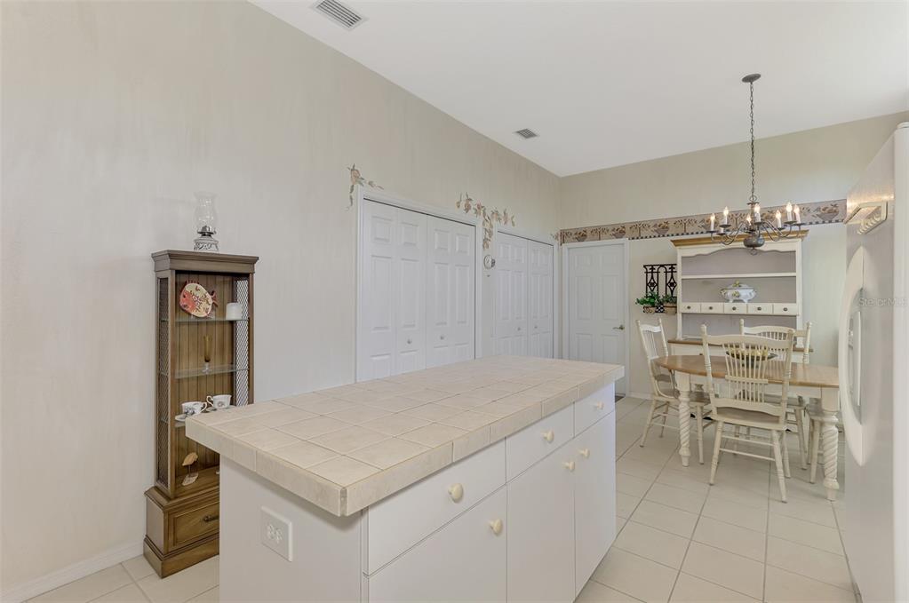 3413 Pennyroyal Road Port Charlotte, FL 33953 - Photo 24 of 88 a kitchen with a table and chairs in it
