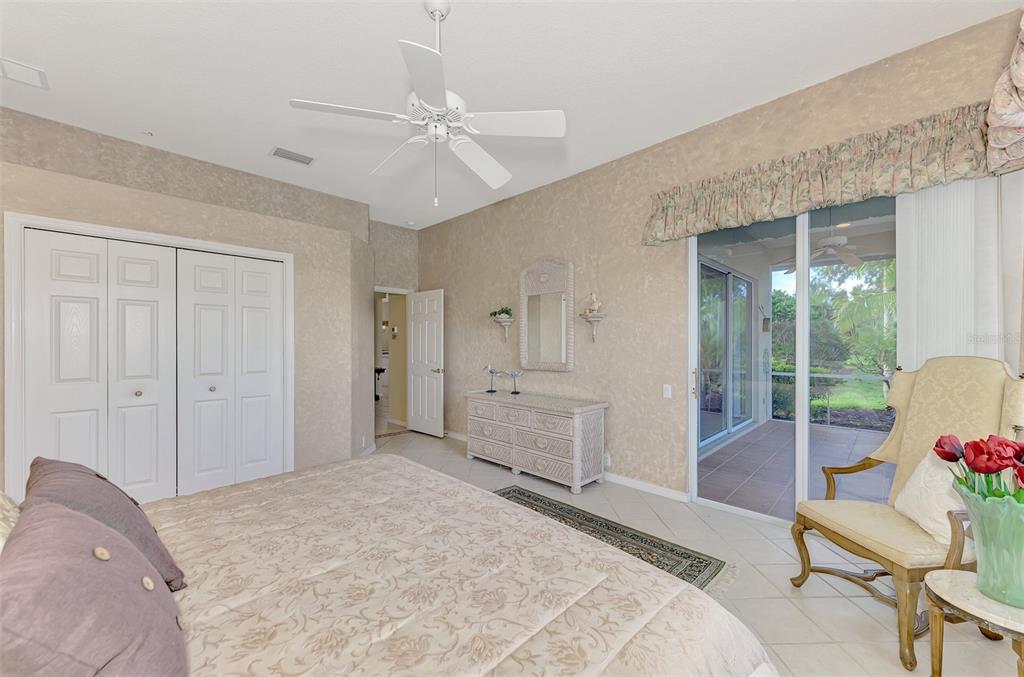 3413 Pennyroyal Road Port Charlotte, FL 33953 - Photo 31 of 88 a spacious bedroom with a bed and glass walk in closet