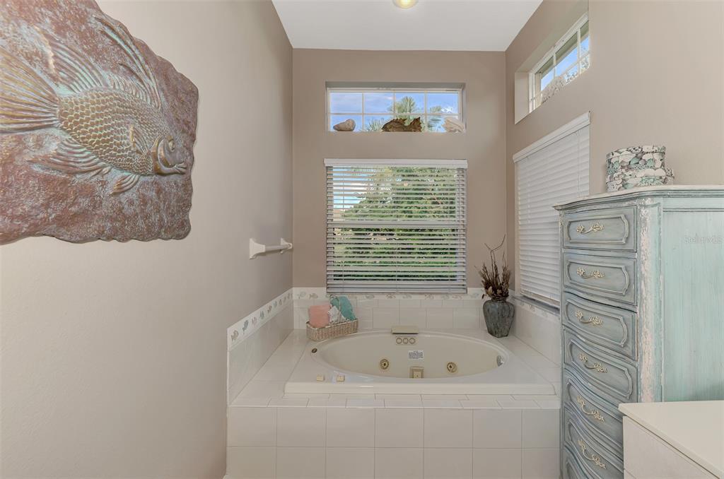 3413 Pennyroyal Road Port Charlotte, FL 33953 - Photo 33 of 88 a bathroom with a sink a window and a shower