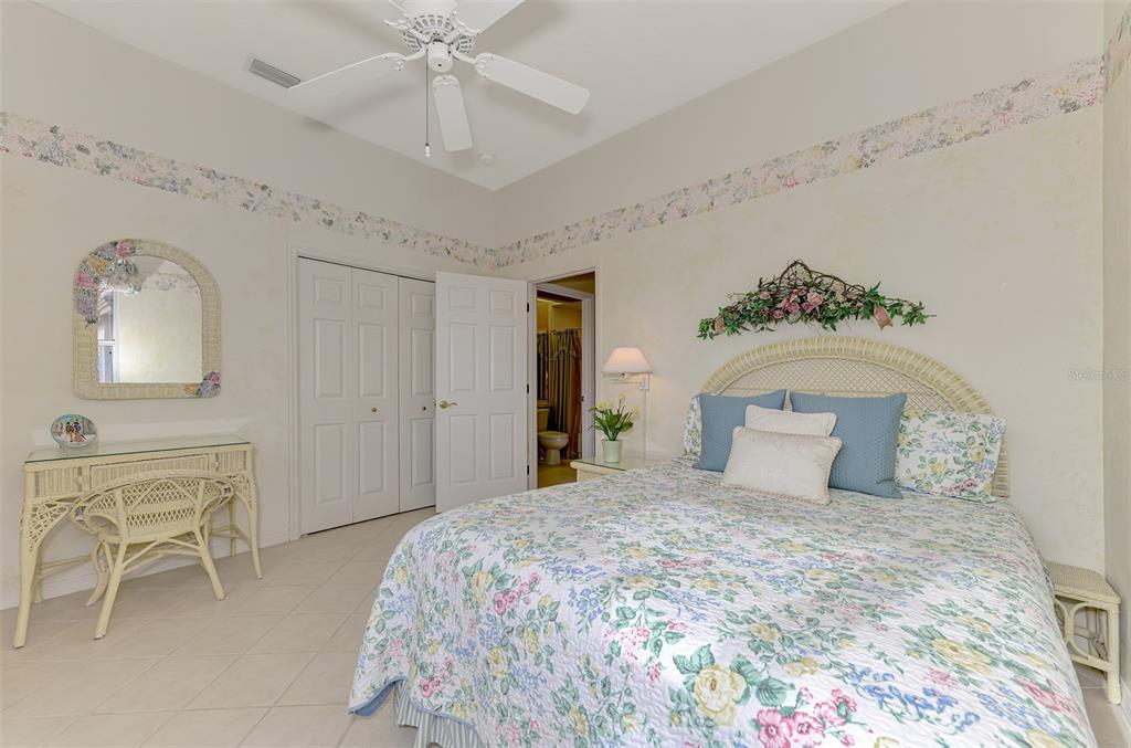 3413 Pennyroyal Road Port Charlotte, FL 33953 - Photo 40 of 88 a bedroom with a large bed and a chandelier