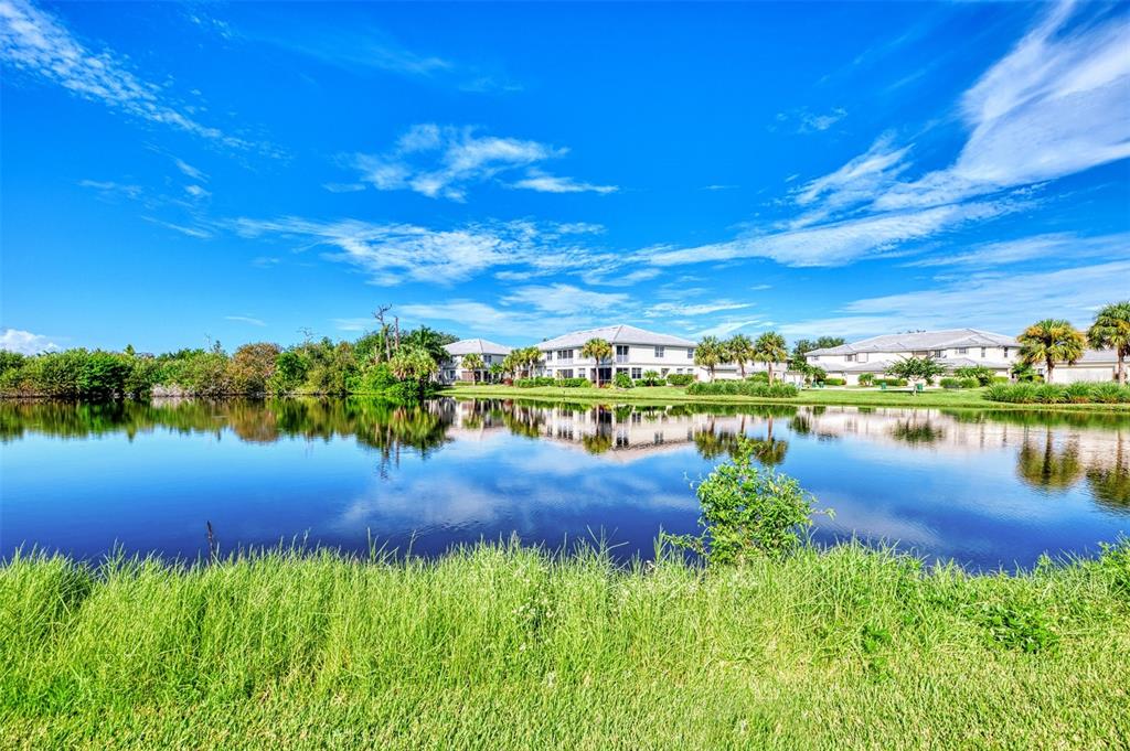 3413 Pennyroyal Road Port Charlotte, FL 33953 - Photo 49 of 88 a view of a lake with lawn chairs