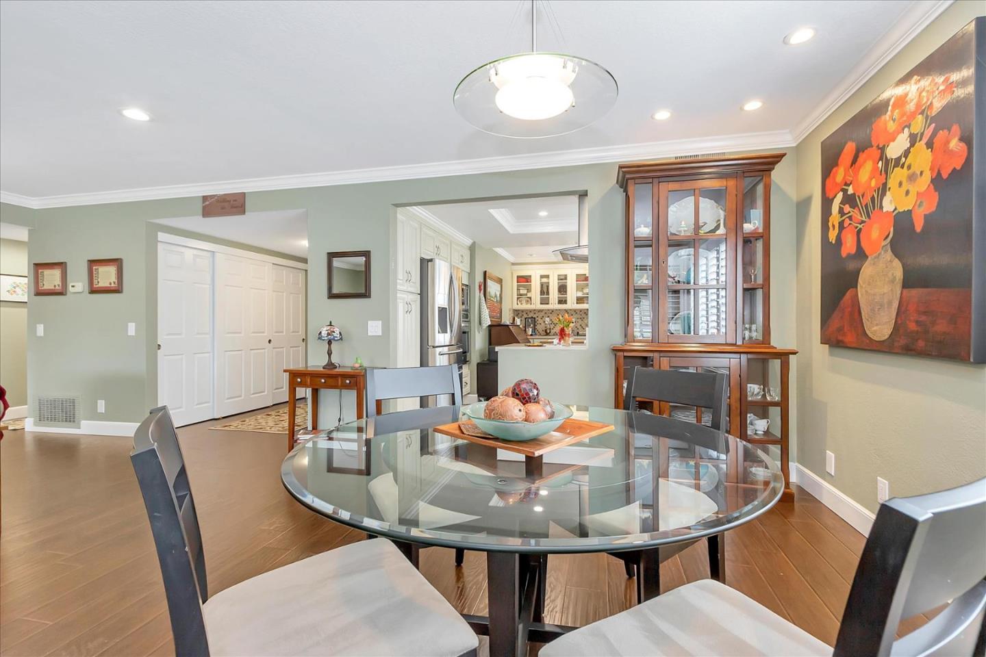 8387 Riesling Way San Jose, CA 95135 - Photo 12 of 52 a view of a dining room with furniture large window and wooden floor