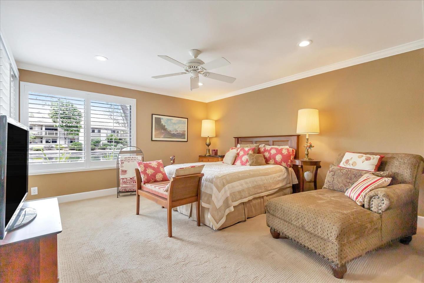8387 Riesling Way San Jose, CA 95135 - Photo 16 of 52 a bedroom with furniture and a flat screen tv