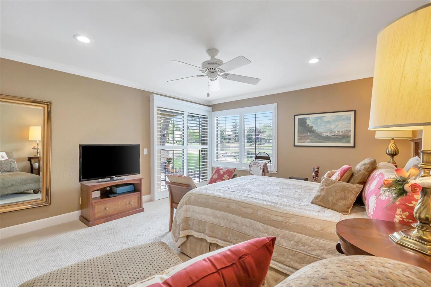 8387 Riesling Way San Jose, CA 95135 - Photo 17 of 52 a bedroom with furniture and a flat screen tv