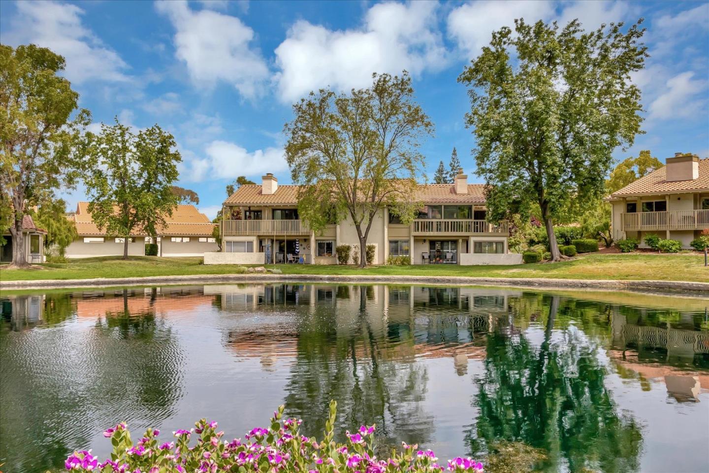 8387 Riesling Way San Jose, CA 95135 - Photo 2 of 52 a view of a lake with houses with yard