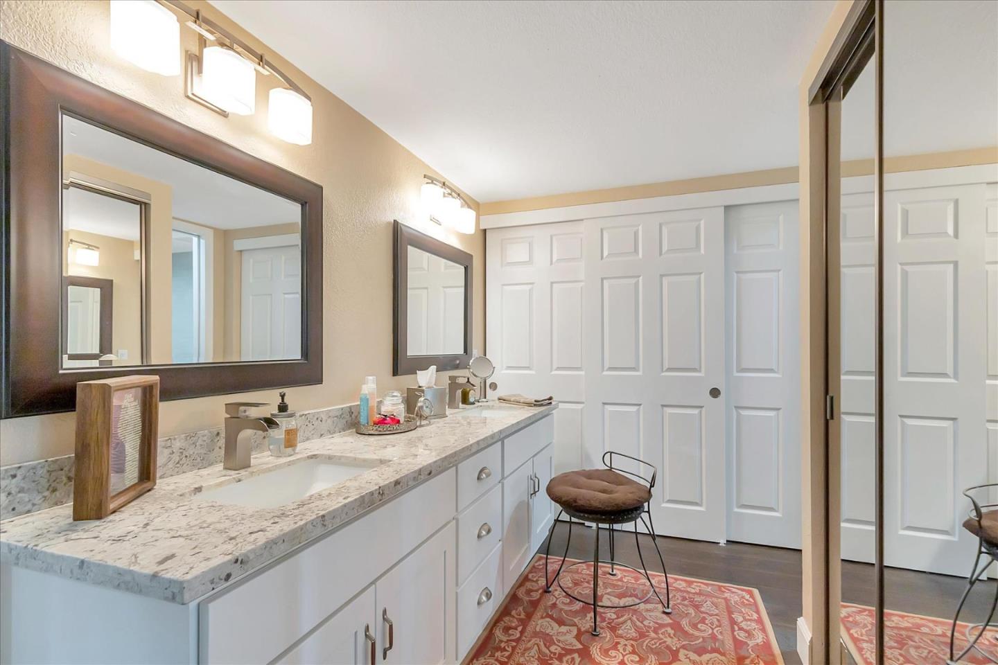 8387 Riesling Way San Jose, CA 95135 - Photo 24 of 52 a bathroom with a granite countertop sink and a mirror