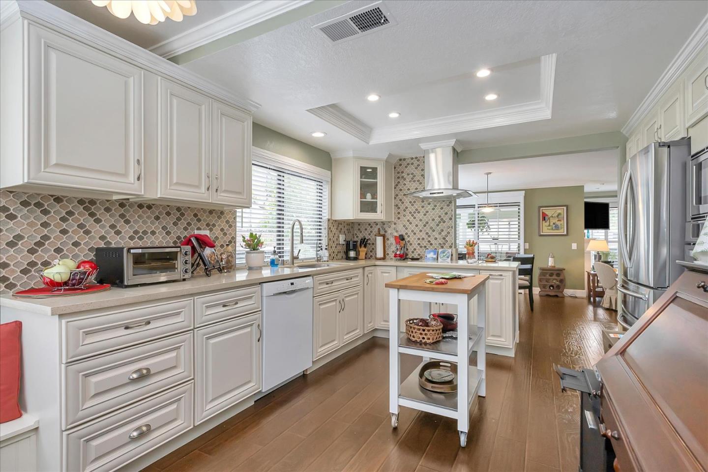 8387 Riesling Way San Jose, CA 95135 - Photo 5 of 52 a kitchen with white cabinets and appliances